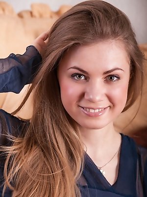 Green-eyed beauty Milliki relaxes on the sofa while giving a full view of her smooth, meaty pussy.